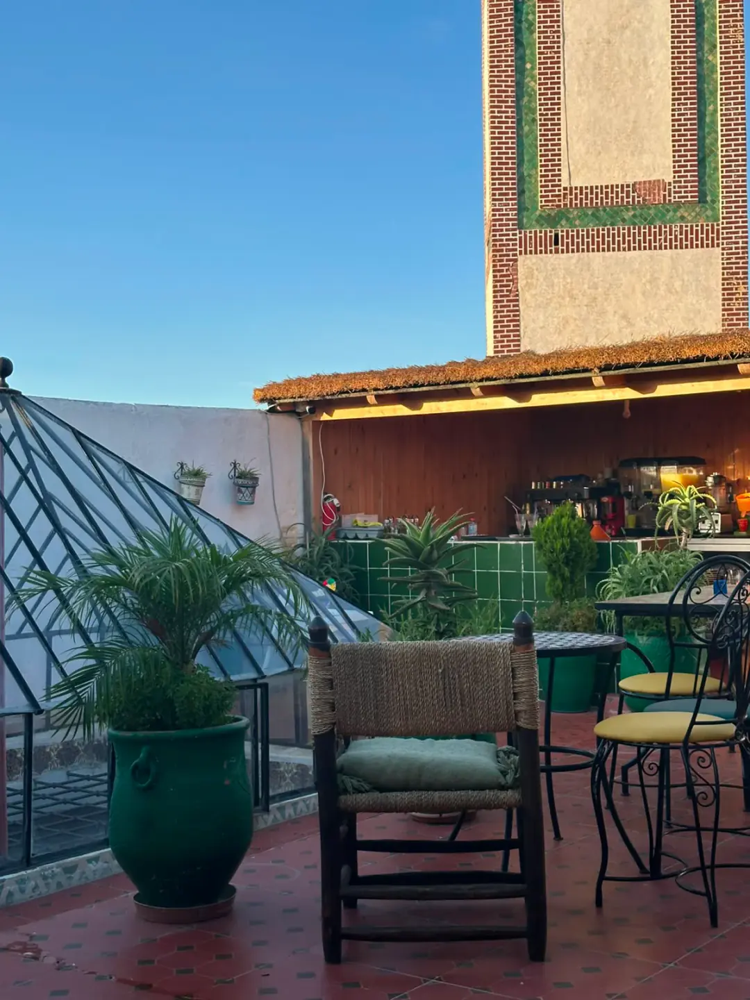 Rooftop terrace at Dar La Medina Tetawen with green tiled bar and open-sky seating