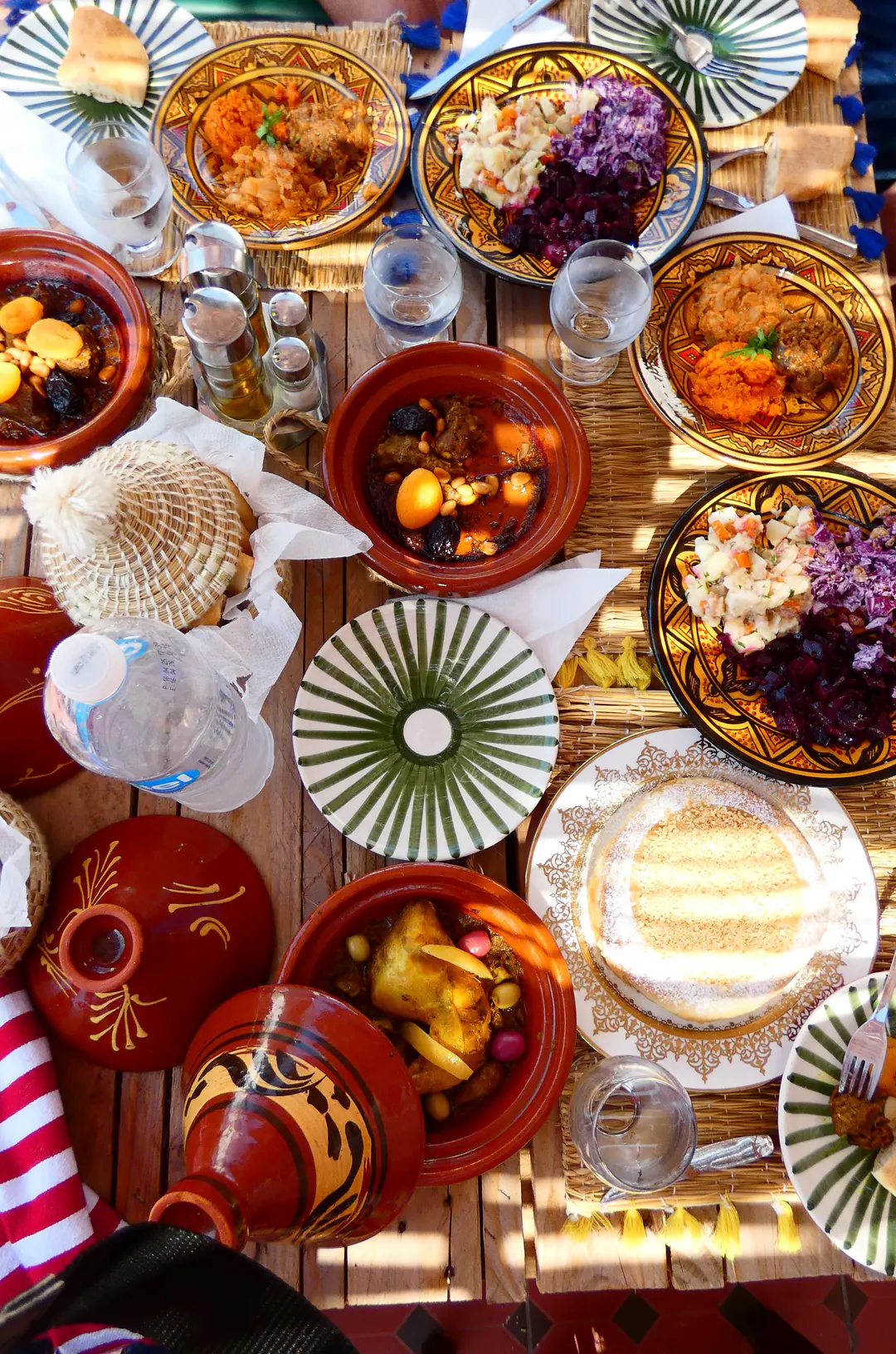 Traditional Moroccan table with tagines and salads