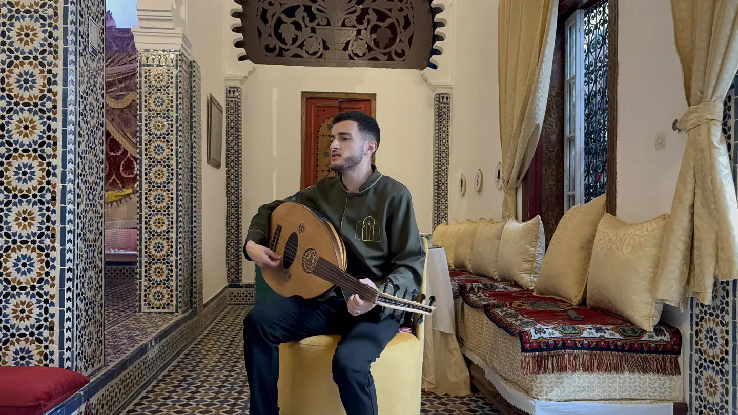 An oud musician playing inside Dar La Medina Tetawen during a private gathering