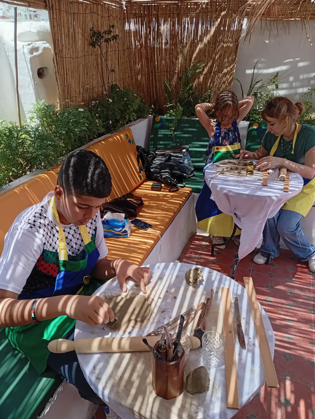 Guests shaping clay during a pottery workshop on the rooftop
